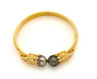 A Tahitian pearl and clearstone bangle. 21ct yellow gold. Weight 27.73 grams. Inside diameter 6cm.