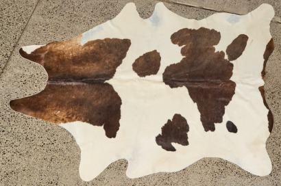 A Black And White Cowhide Floor Rug