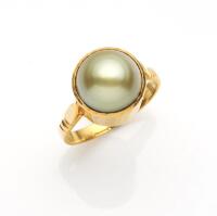 A Tahitian pearl ring, the 10.4mm green pearl in a bezel setting. 21ct yellow gold. Weight 5.44 grams. Size H.