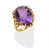 An amethyst and diamond cocktail ring, the fancy cut pear-shaped amethyst in a pierced diamond set surround. Known total diamond weight 0.24 carat.  18ct yellow gold. Weight 9.95 grams. Size M.