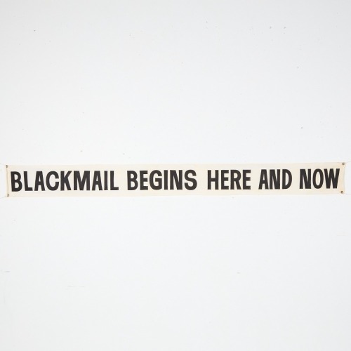 A 'Blackmail Begins Here And Now' Banner