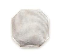 A sterling silver Art Deco compact, of octagonal design. Engine turned decoration. Diameter 7cm. Birmingham hallmarks.