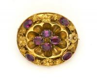 A Victorian almandine garnet brooch, of oval design, locket insert to reverse. Yellow gold. Weight 10.18 grams. Length 35mm.