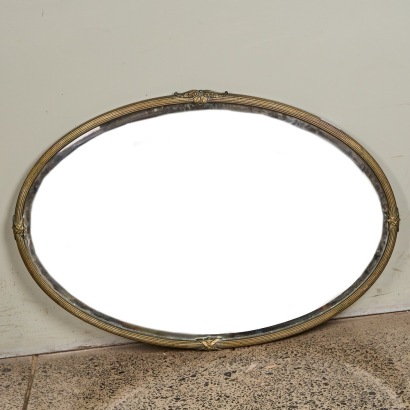 An Art Deco Brass Oval Bevelled Mirror