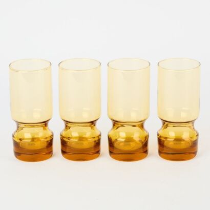 A Set of Four Tall Amber Glass Glasses