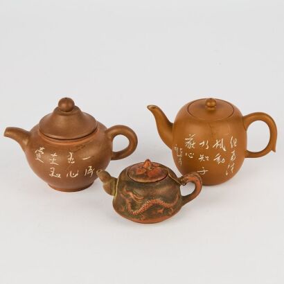 A Group of Three Chinese Purple Clay Small Teapots