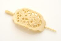 A vintage hair pin, carved ivorine, dragon motif. Length 11cm.