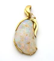 An opal and diamond pendant, handmade and set with a fossilised opal shell, and a trilliant cut diamond. 18ct yellow gold. Weight 10 grams. Length 40mm.&nbsp;