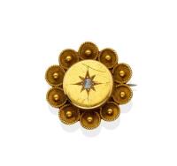 A Victorian target brooch, of circular form, set with a central rose cut diamond. 15ct yellow gold. Weight 4.3 grams. Diameter 24mm.