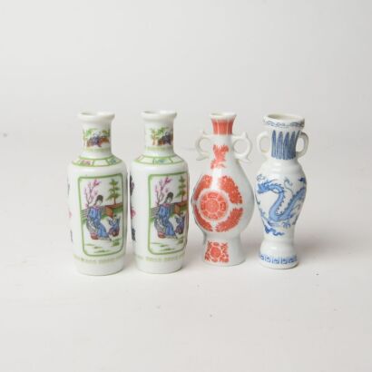 A Group of Four Chinese Painted Figures and Dragon Snuff Bottles