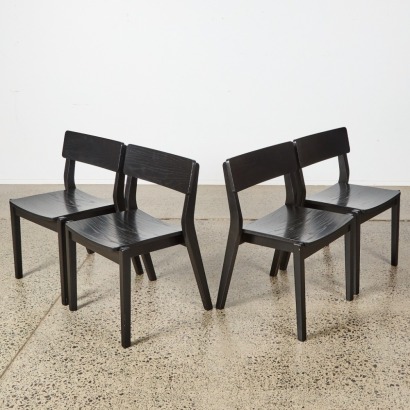 A Suite of Four Black Solid Oak Chairs