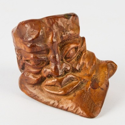 A Small Wood Carving of a Face