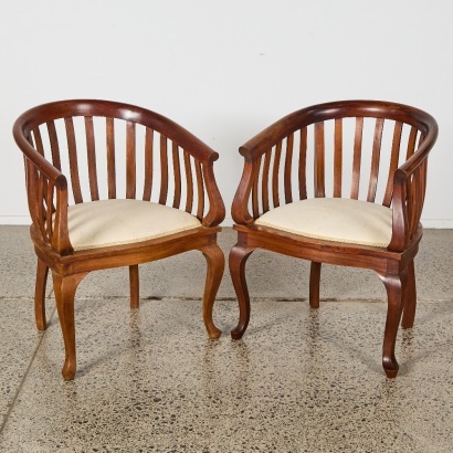 A Pair of Teak Round Back Chairs