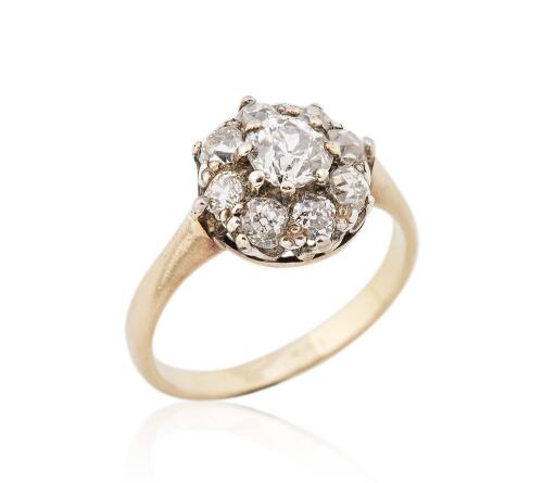 An antique diamond cluster ring, set with nine old European cut diamonds. Total estimated weight  1.20 carats. 18ct yellow gold. Weight 3.81 grams. Size O.