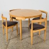 A Hans Olsen Roundette Style Dining Table With Four Nested Chairs