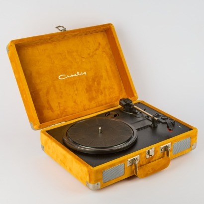 A Crosley Suitcase Turntable with Four Assorted Records