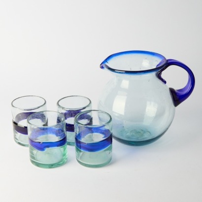 A Glass Jug And Four Glasses