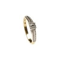 A solitaire diamond ring, four claw set with a round brilliant cut diamond and thirty-two small single diamonds set in double rows on either side. 18ct yellow gold. Weight 3.43 grams. Size N.