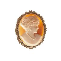 A cameo brooch, the oval helmet shell cameo with carved female profile. 9ct rose gold. Weight 9.34 grams. Length 44mm.