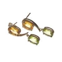 A pair of citrine and peridot pendant earrings, each set with an oval peridot and citrine. 925 silver. Weight 3.77 grams. Post and butterfly attachments. Length 26mm.