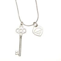 A key pendant and padlock charm, Tiffany & Co. Sterling silver. To be sold with an 18ct white gold chain. Weight 14.89 grams. Length 55.5cm. Box and pouch.