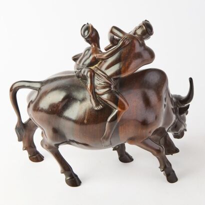 A South Asian Wooden Carving of a Herd Boy on an Ox