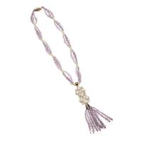 An amethyst and pearl sautoire, of multi-strand design, hung with an amethyst and diamond clasp. 9ct rose gold. Length of necklace 40cm. Length of pendant 10.5cm.