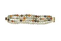 A jade bracelet, the multi-colour bracelet of four strand design. Silver gilt clasp. Length 18cm.