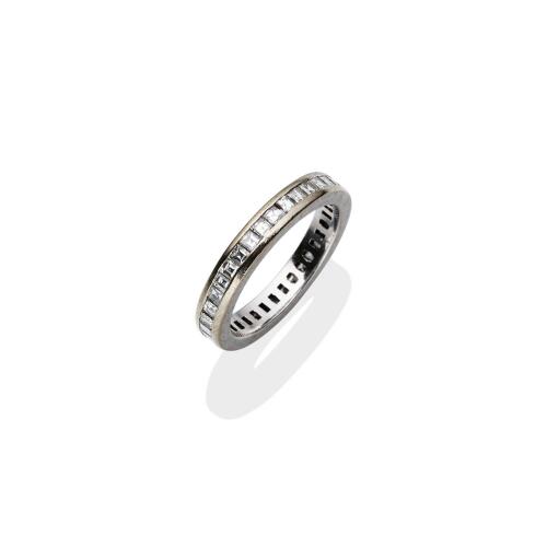 A diamond eternity ring, channel set all around with thirty-six princess cut diamonds of estimated total weight 1.50 carats. 18ct white gold. Weight 6.28 grams. Size R½. Gemmologist's report available.