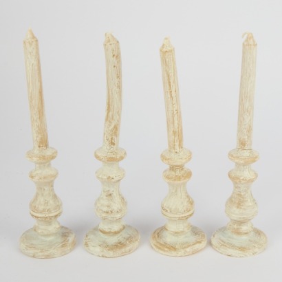 A Set Of Four Small Formed Table Candles