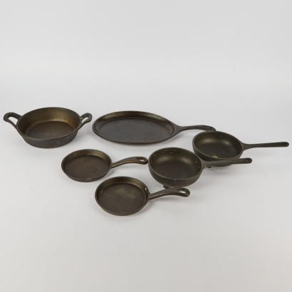 A Collection Of Six Cast Iron Sizzle Pots
