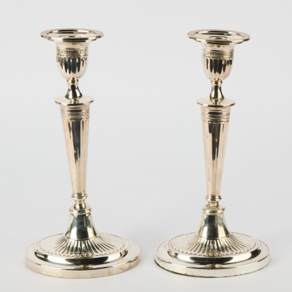A Pair of Silver Coloured Candlesticks