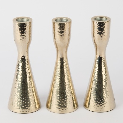 A Set of Three Beaten Candlestick Holders