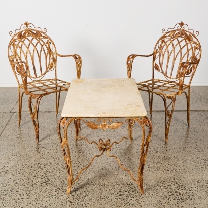A Pair of Vintage French Wrought Iron Chairs and Marble Topped Table With Floral Motifs