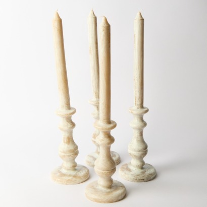 A Set of Four Large Moulded Wax Candles