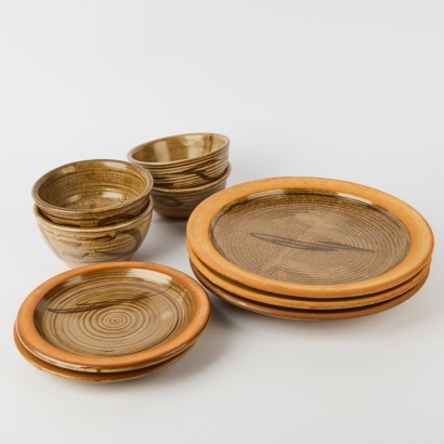 A Set of Nine Glazed Terracotta Plates And Bowls