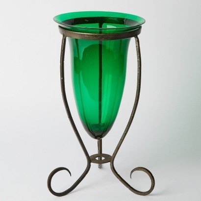 A Green Glass Vase In Iron Holder