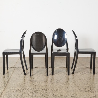 A Set Of Four Kartell Style Black Ghost Chairs