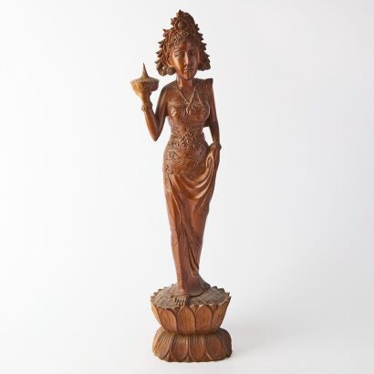 A Carved Wooden Figure of a Young Indonesian Girl