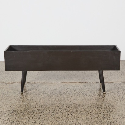 A Mid-Century Style Planter Box With Stainless Steel Tray