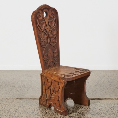 An Ornately Carved Childs Chair
