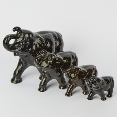A Set of Four Black Crown Lynn Elephants