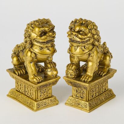 A Pair of Chinese Resin Carved Lions