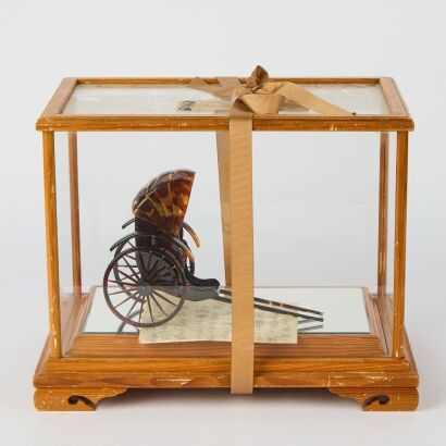 A Japanese Tortoiseshell Style Figural Ornament of a Rickshaw