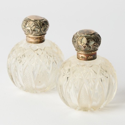A Pair of Antique Cut Crystal Perfume Bottles with Sterling Lids