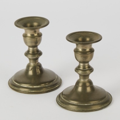 A Pair of Ornate Pewter Candlesticks