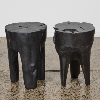 A Pair of Ebonised Solid Teak Log Stools