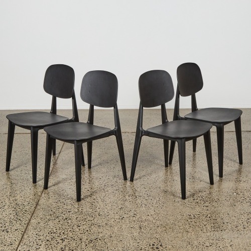 A Suite of Four Black Mid Century Style Dining Chairs