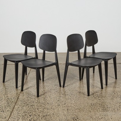 A Suite of Four Black Mid Century Style Dining Chairs