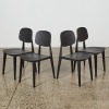 A Suite of Four Black Mid Century Style Dining Chairs